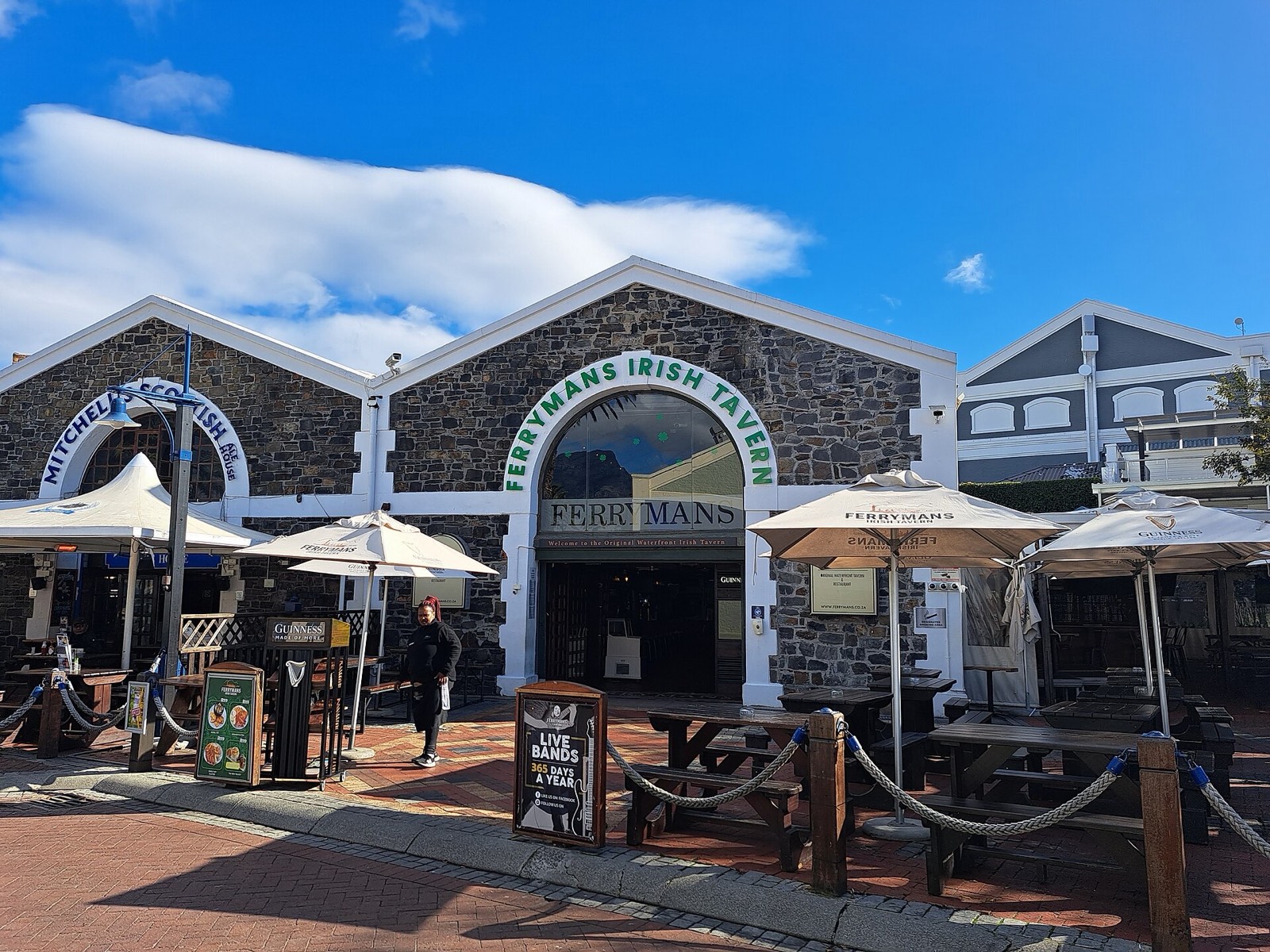Ferrymans Irish Tavern in the old stone Locomotive Shed on Dock Road, garden umbrellas out front