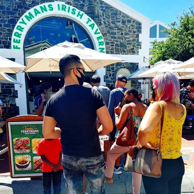 The garden seating under Ferrymans umbrellas outside the stone tavern