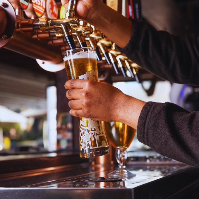 A bartender pouring a draught at the Ferrymans taps